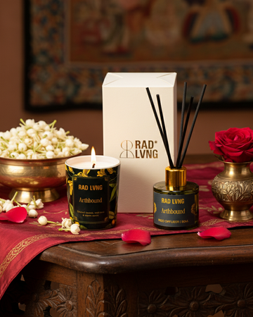 Arthbound grounding candle and reed diffuser duo in elegant glass vessels evoking warm earth and sacred woods scent