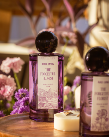 Luxury space scent mist evoking soft chaos with green stems and sage notes