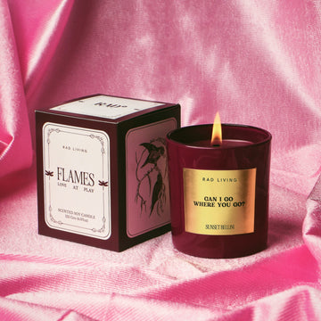 Sunset Bellini scented candle in glass jar with warm orange glow